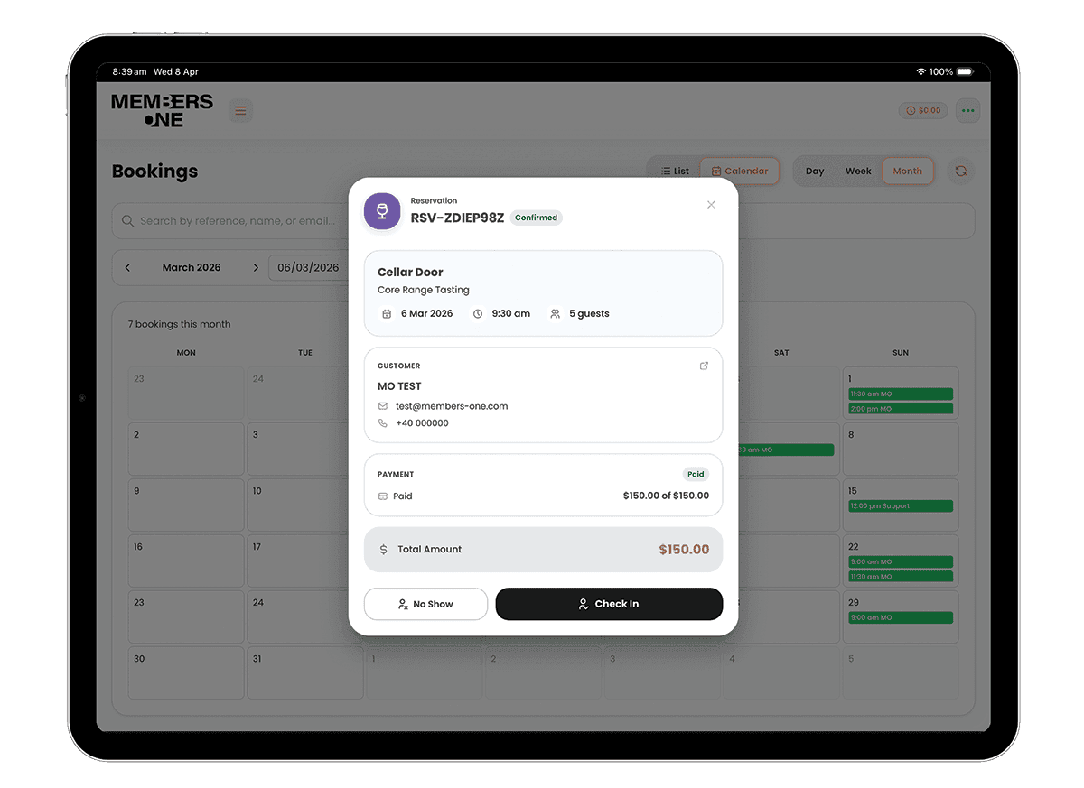 Members One POS bookings screen on tablet showing monthly calendar view with reservation detail modal including customer info, payment status and check-in options